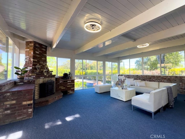 interior space featuring beamed ceiling and a brick fireplace