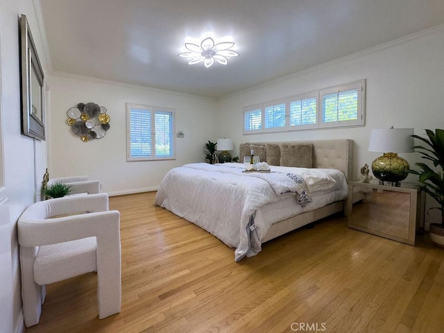 bedroom with light wood-type flooring, multiple windows, and ornamental molding