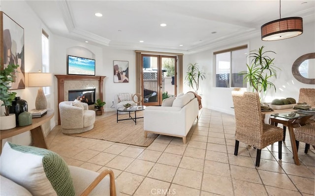 living room featuring a glass covered fireplace, recessed lighting, and ornamental molding