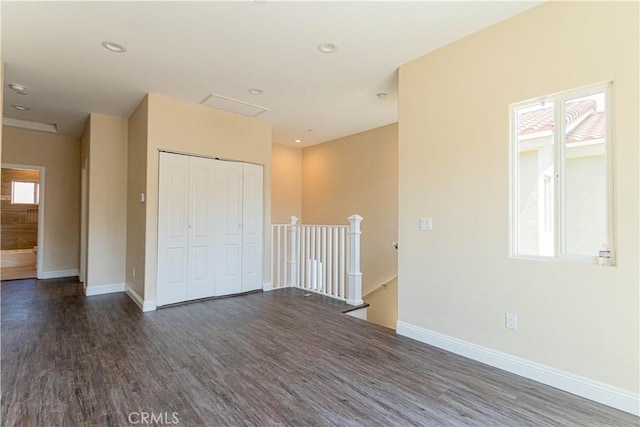 empty room with recessed lighting, baseboards, and wood finished floors