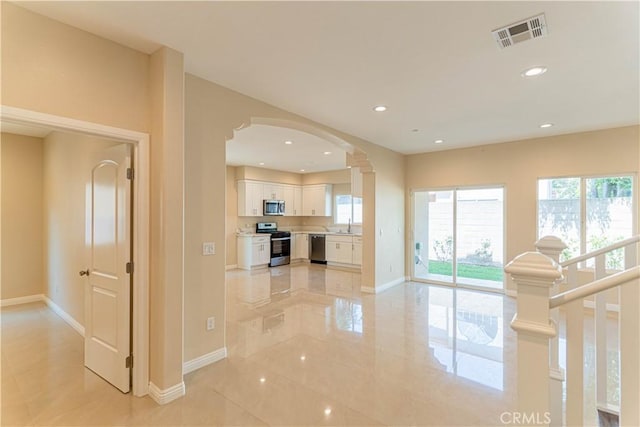 interior space with recessed lighting, visible vents, and baseboards