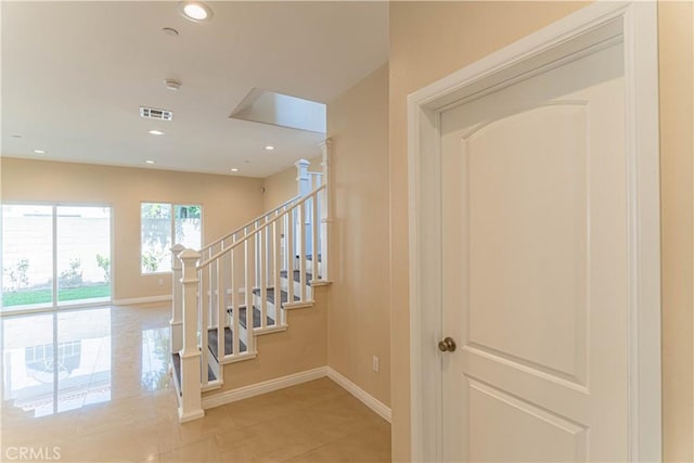 stairs featuring recessed lighting, visible vents, baseboards, and tile patterned floors