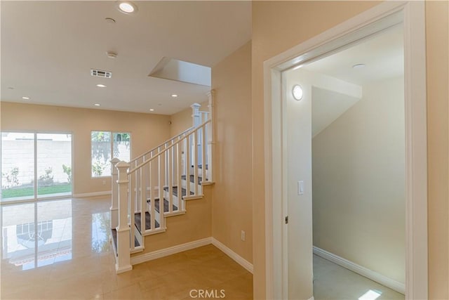 staircase with recessed lighting, visible vents, and baseboards