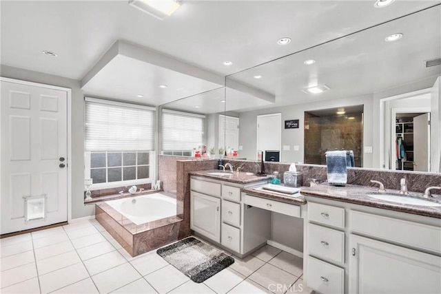 bathroom with tile patterned flooring, a sink, and double vanity