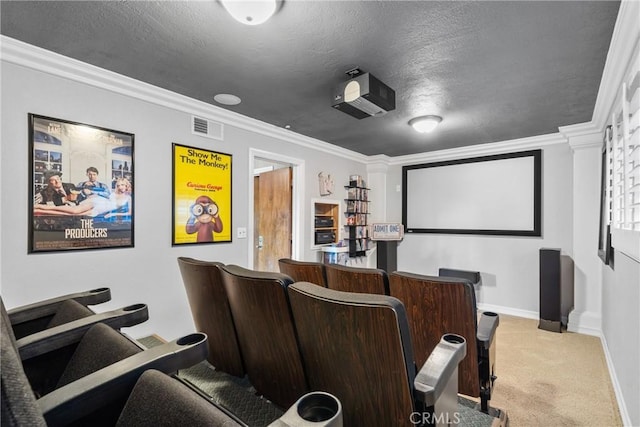 carpeted home theater featuring crown molding, baseboards, visible vents, and a textured ceiling