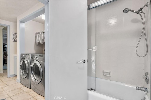 bathroom featuring washing machine and clothes dryer and combined bath / shower with glass door
