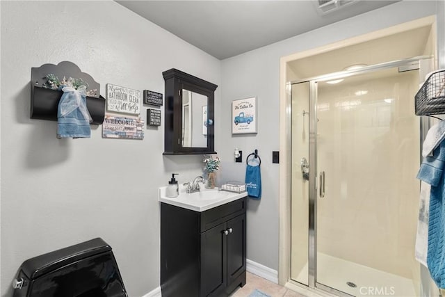 bathroom featuring visible vents, a shower stall, baseboards, tile patterned floors, and vanity