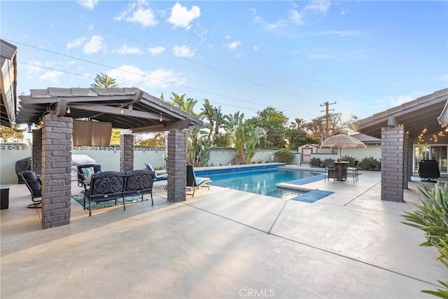 view of swimming pool featuring a patio area, a fenced in pool, a fenced backyard, and an outdoor hangout area