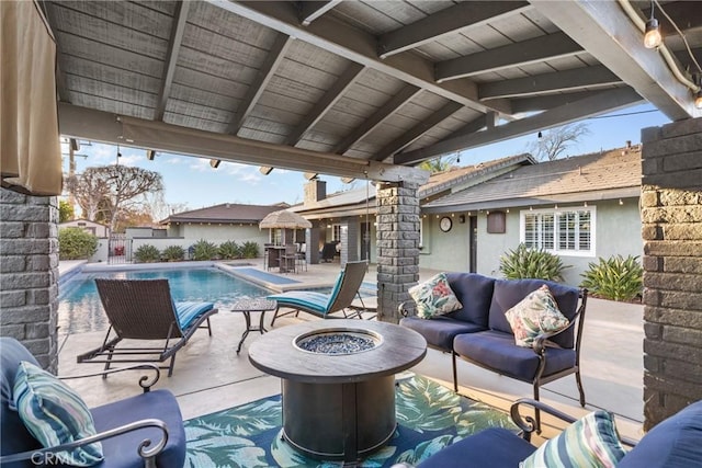 view of patio with a fenced in pool, an outdoor living space with a fire pit, and a fenced backyard