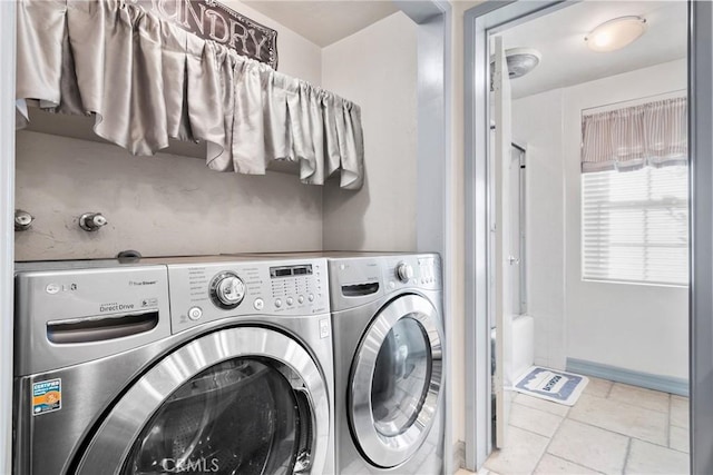 clothes washing area featuring washing machine and clothes dryer and laundry area