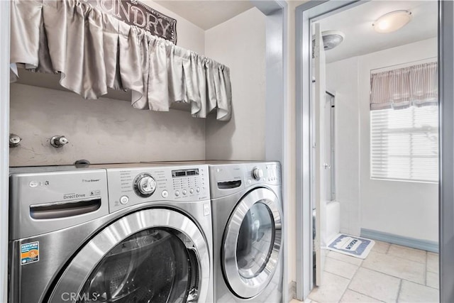 clothes washing area with washer and dryer and laundry area