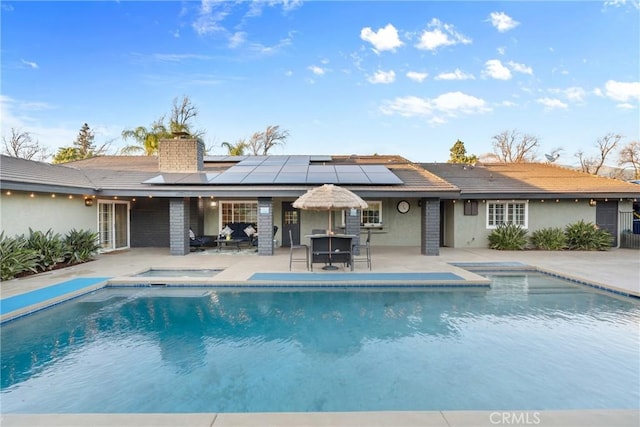 outdoor pool featuring outdoor dining space and a patio area