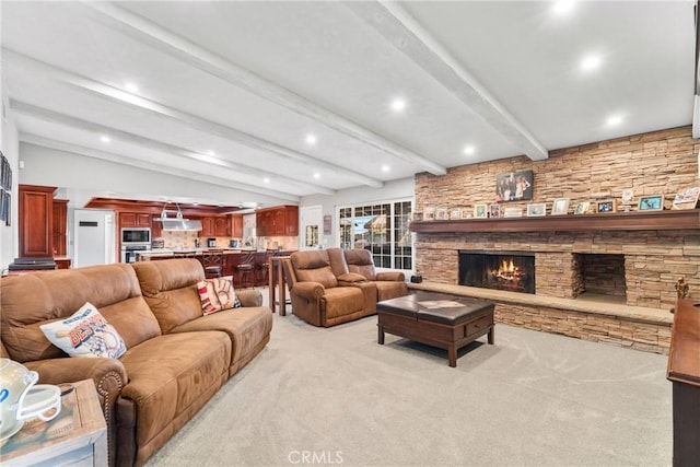 living room with a fireplace, vaulted ceiling with beams, light colored carpet, and recessed lighting