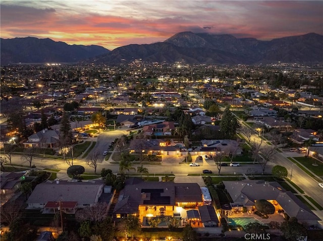 aerial view at dusk featuring a mountain view