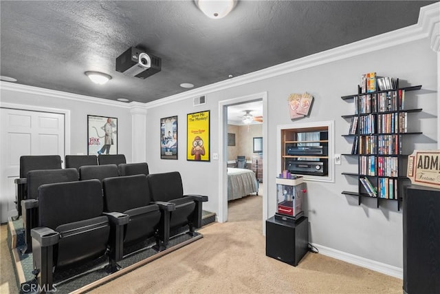 home theater featuring visible vents, a textured ceiling, carpet flooring, crown molding, and baseboards