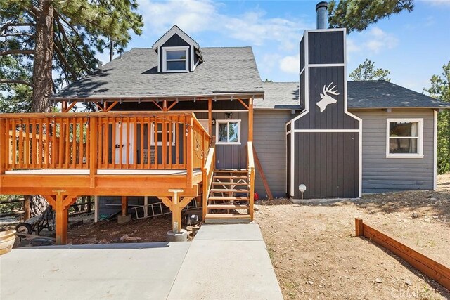 view of front of house with a shingled roof