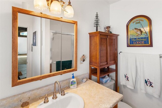 bathroom with an enclosed shower, toilet, and vanity