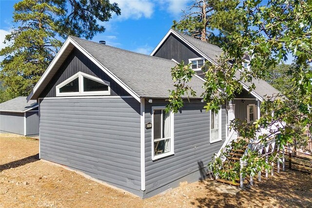 view of home's exterior with a shingled roof