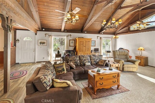 living area featuring lofted ceiling with beams, a wealth of natural light, and ceiling fan