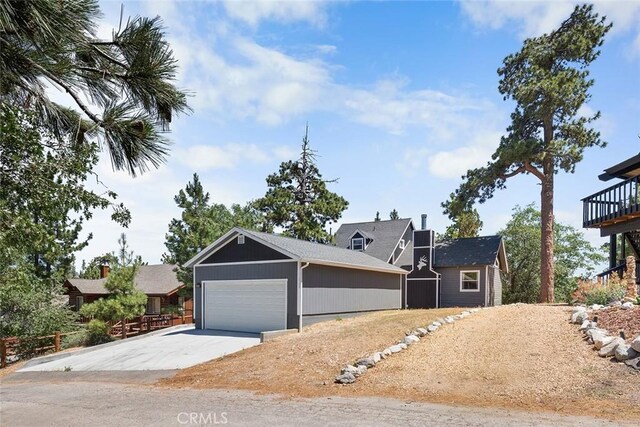 view of front of house featuring concrete driveway and an attached garage