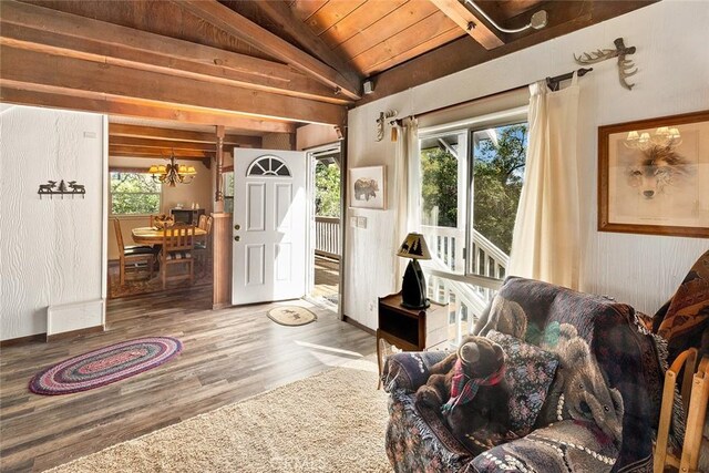 living area featuring an inviting chandelier, plenty of natural light, wood ceiling, and vaulted ceiling with beams