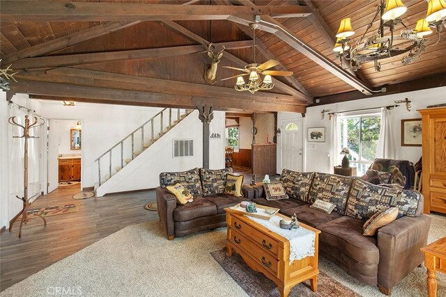 living room featuring stairway, vaulted ceiling with beams, wood ceiling, and visible vents