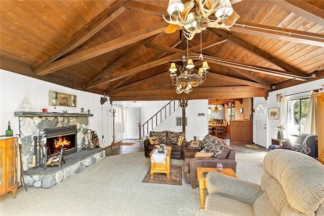 living room featuring stairway, wood ceiling, lofted ceiling with beams, a stone fireplace, and a notable chandelier