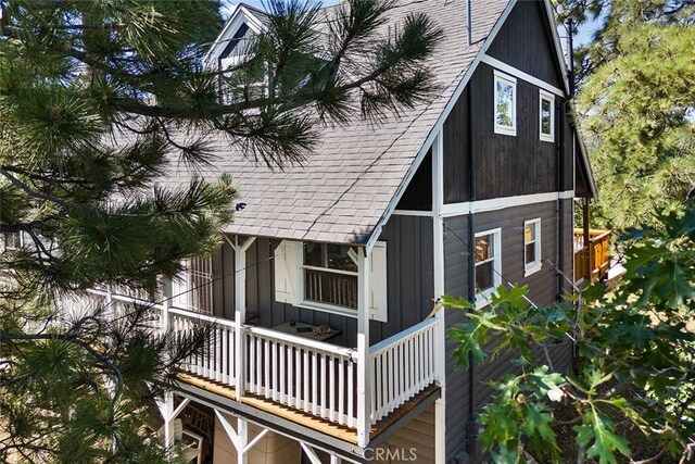 view of front of house with board and batten siding and roof with shingles