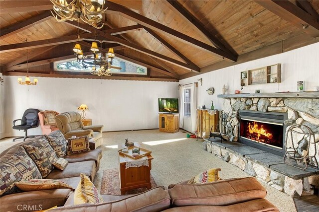 carpeted living room with a wealth of natural light, lofted ceiling with beams, a chandelier, and a fireplace