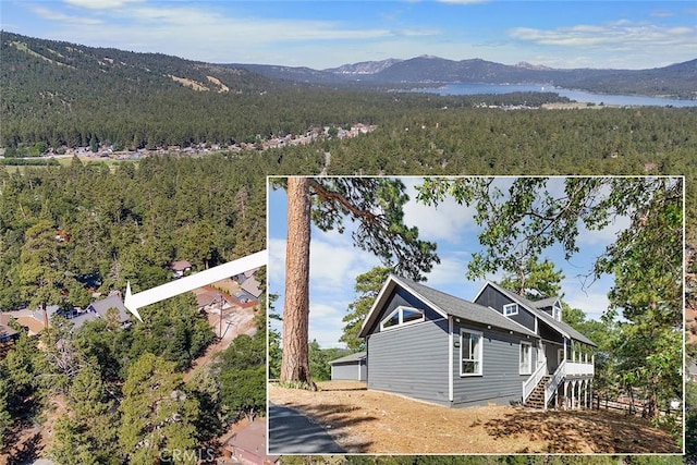 aerial view with a mountain view and a wooded view