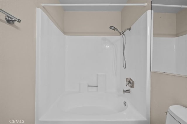 bathroom with toilet and  shower combination