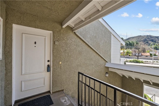 doorway to property featuring stucco siding and a mountain view