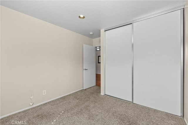 unfurnished bedroom featuring a closet and carpet floors