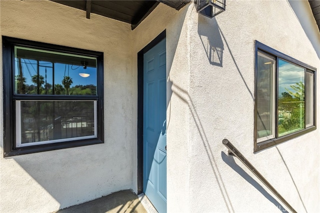 doorway to property with stucco siding