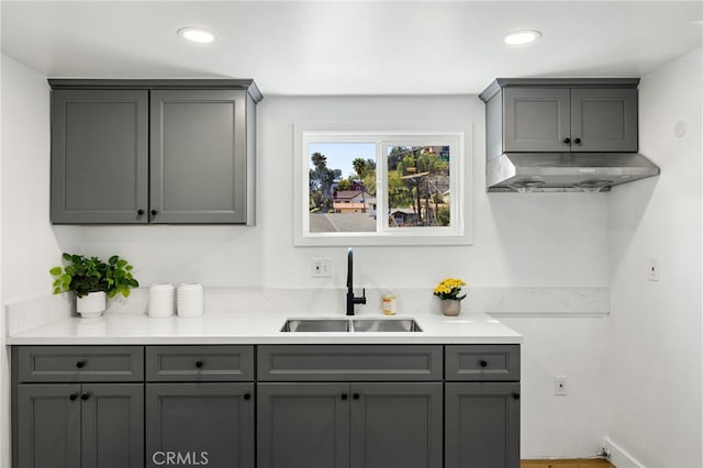 kitchen with a sink, gray cabinetry, and recessed lighting