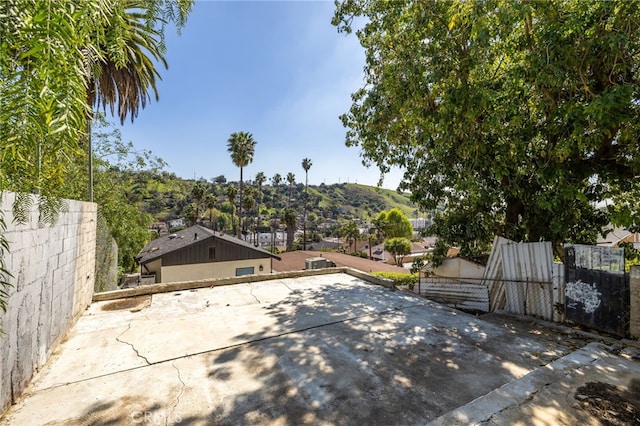 view of patio featuring fence and a mountain view