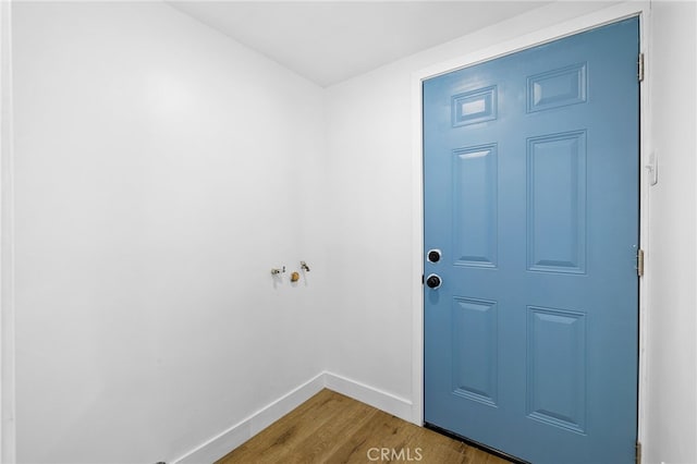 interior space with baseboards and wood finished floors