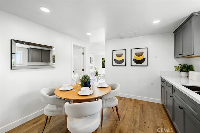 dining room featuring recessed lighting, baseboards, and wood finished floors