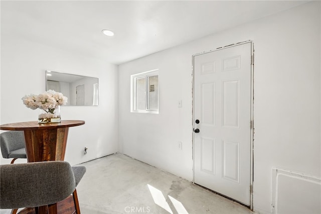 entrance foyer with unfinished concrete flooring