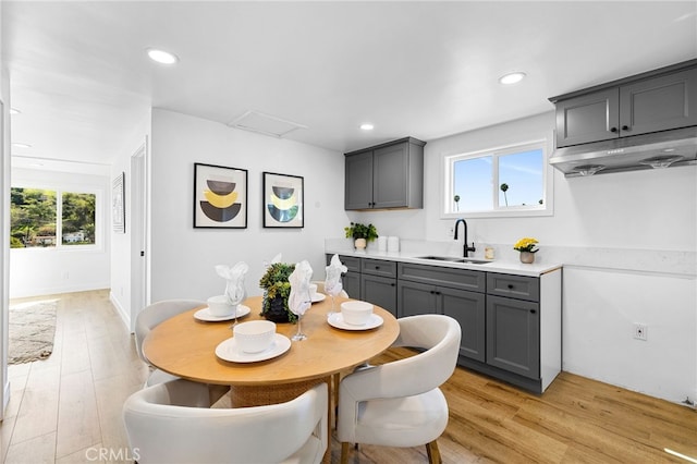 dining space with recessed lighting, light wood-type flooring, and attic access