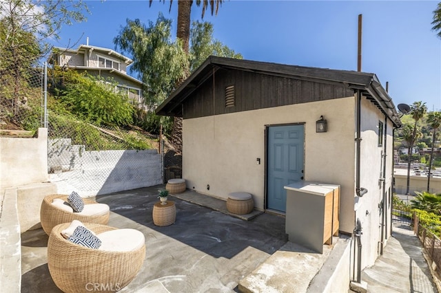 view of outbuilding featuring fence