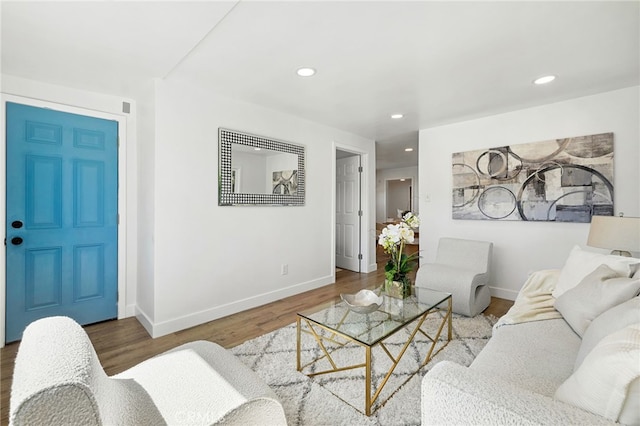 living room featuring recessed lighting, baseboards, and wood finished floors