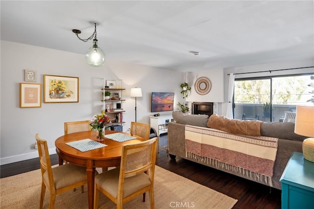 dining space featuring baseboards and wood finished floors