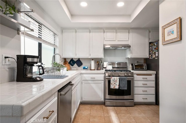 2032 E Bermuda St Unit 102, Long Beach, CA 90814 - kitchen featuring appliances with stainless steel finishes, tile counters, a tray ceiling, and recessed lighting