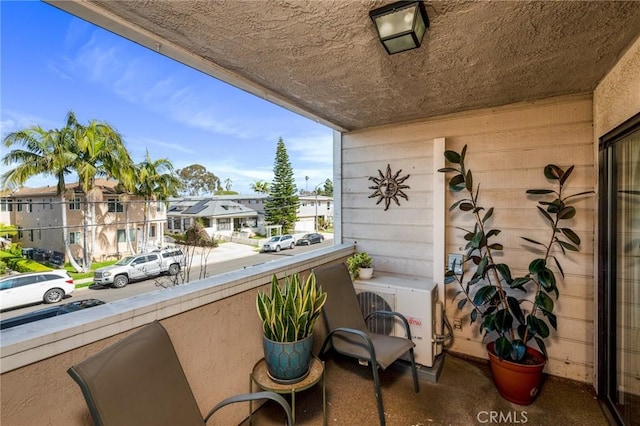 balcony featuring ac unit and a residential view