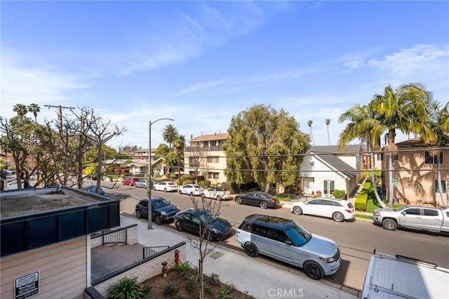 view of street featuring a residential view, street lighting, and sidewalks