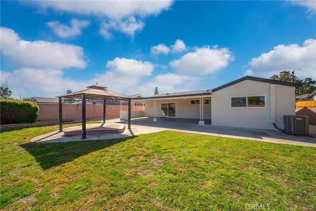 back of house featuring a patio, a yard, central AC, a gazebo, and fence