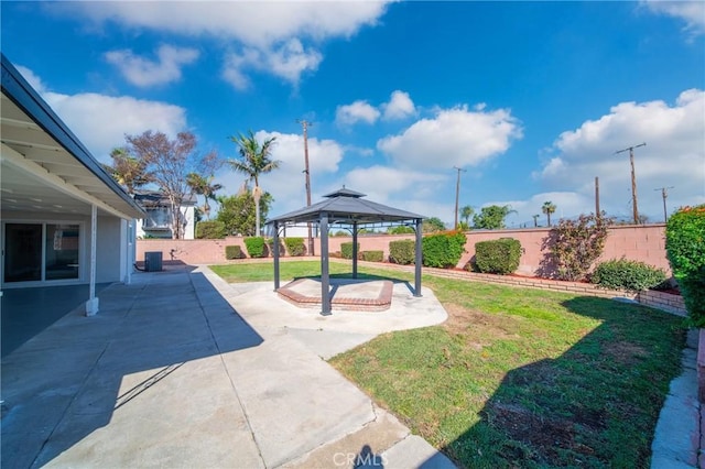 view of yard featuring a patio area, a fenced backyard, and a gazebo