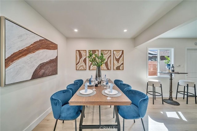 dining space with baseboards, recessed lighting, and wood finished floors