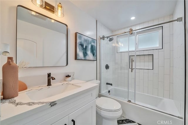 full bathroom featuring toilet, vanity, and bath / shower combo with glass door